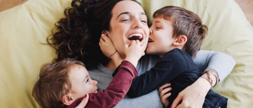 a person holding a couple of children