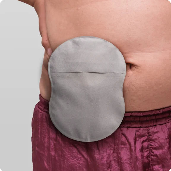 Light gray ostomy bag with leak defense and soft convexity, providing a lasting seal on a man's belly.