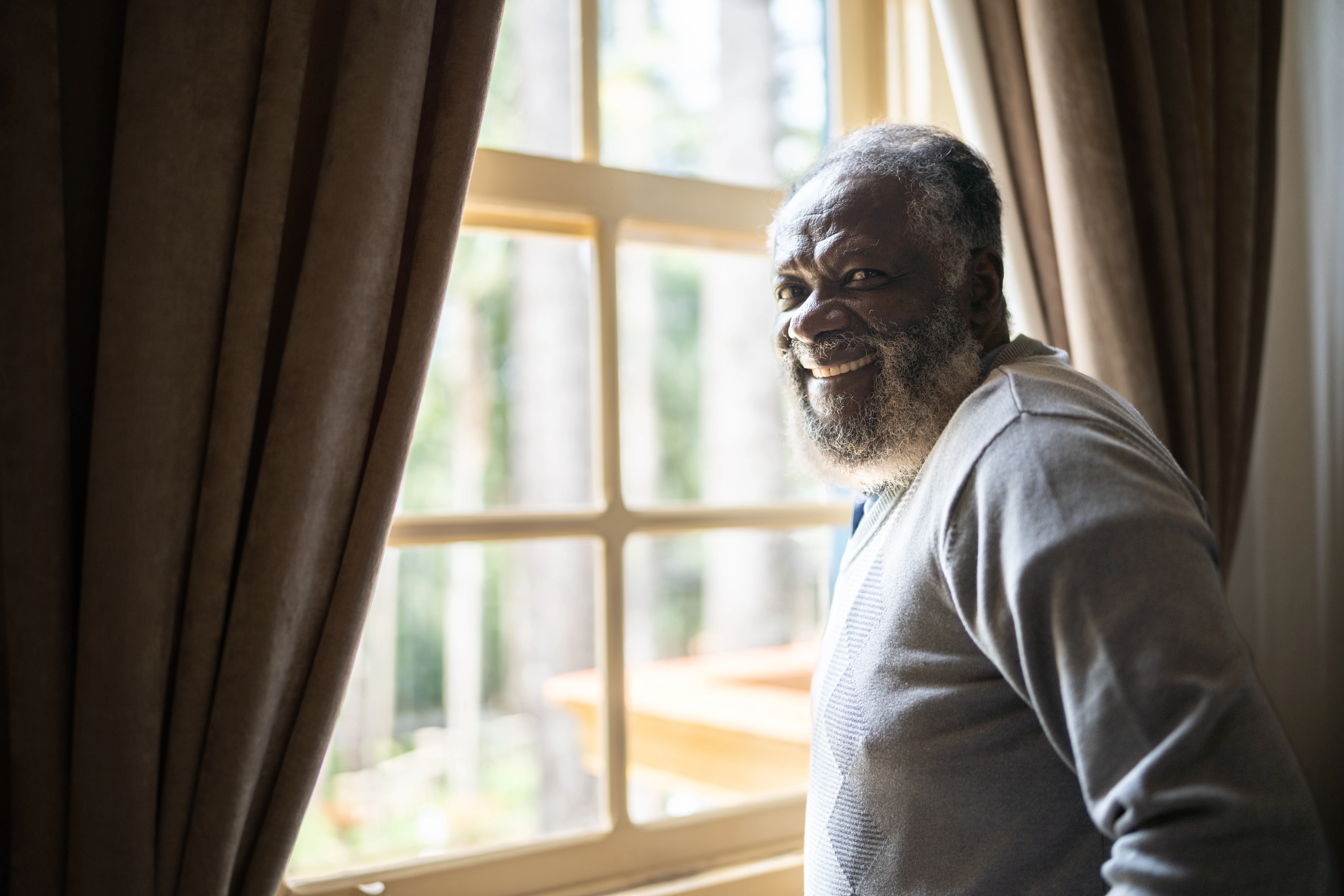 a man leaning against a window