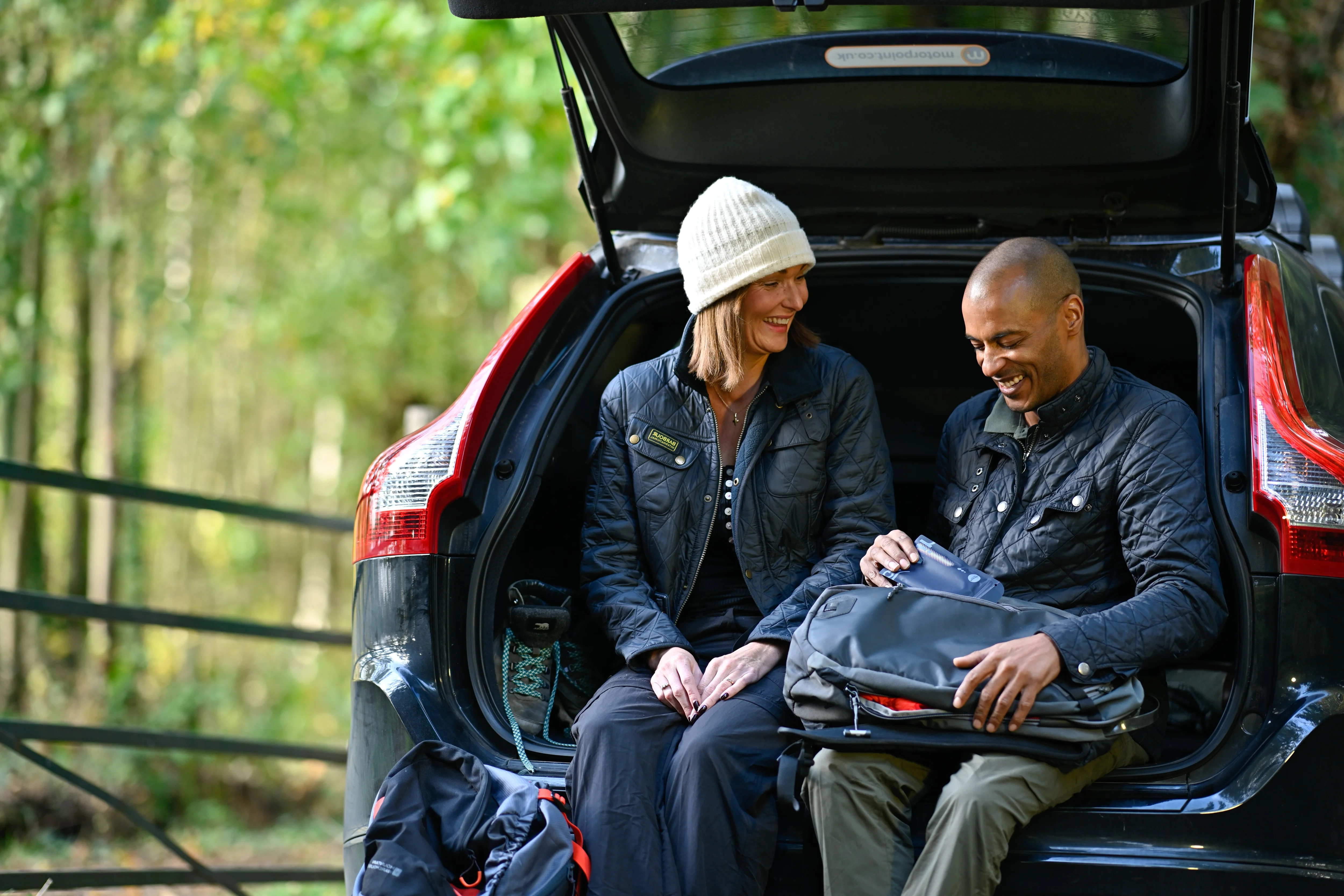 a man and woman in the back of a car