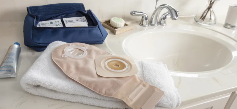 a bathroom sink with towels and a box on the counter