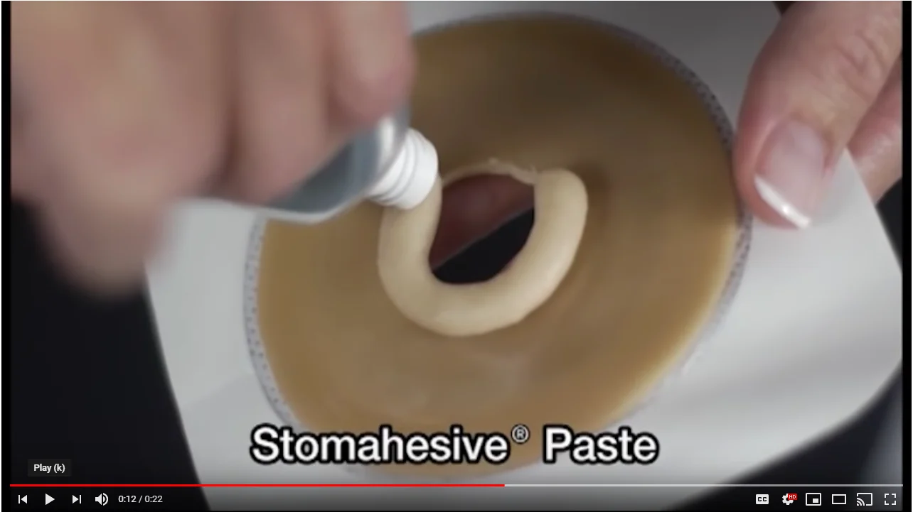 a person holding a white tube