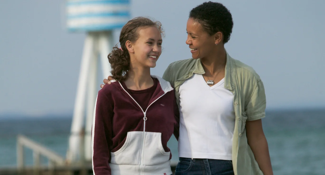 a woman holding another woman and smiling